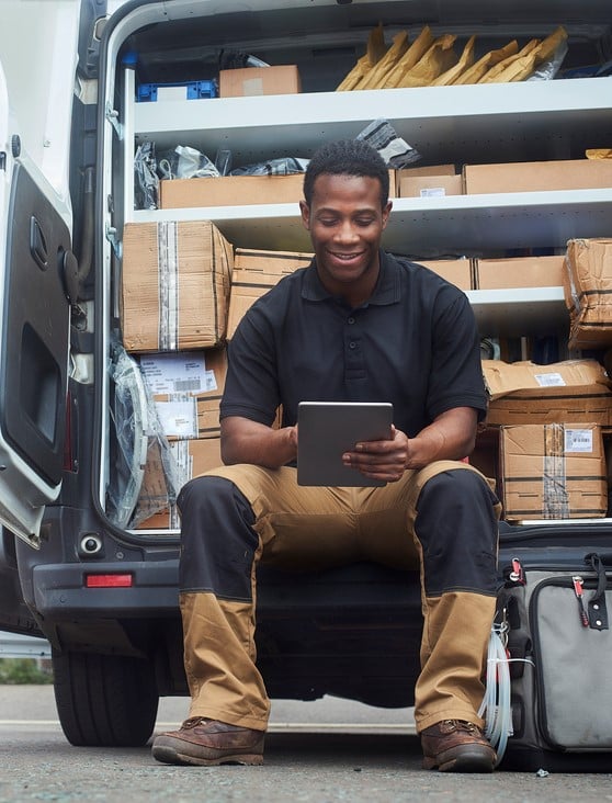 Service engineer sat at the back of his van