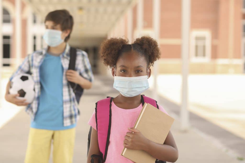 African descent, girl on school campus. Mask for COVID-19.