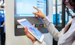 Close-up of a woman engineer looking at her digital tablet while testing a machine. Engineer analyzing machine data on her digital tablet.